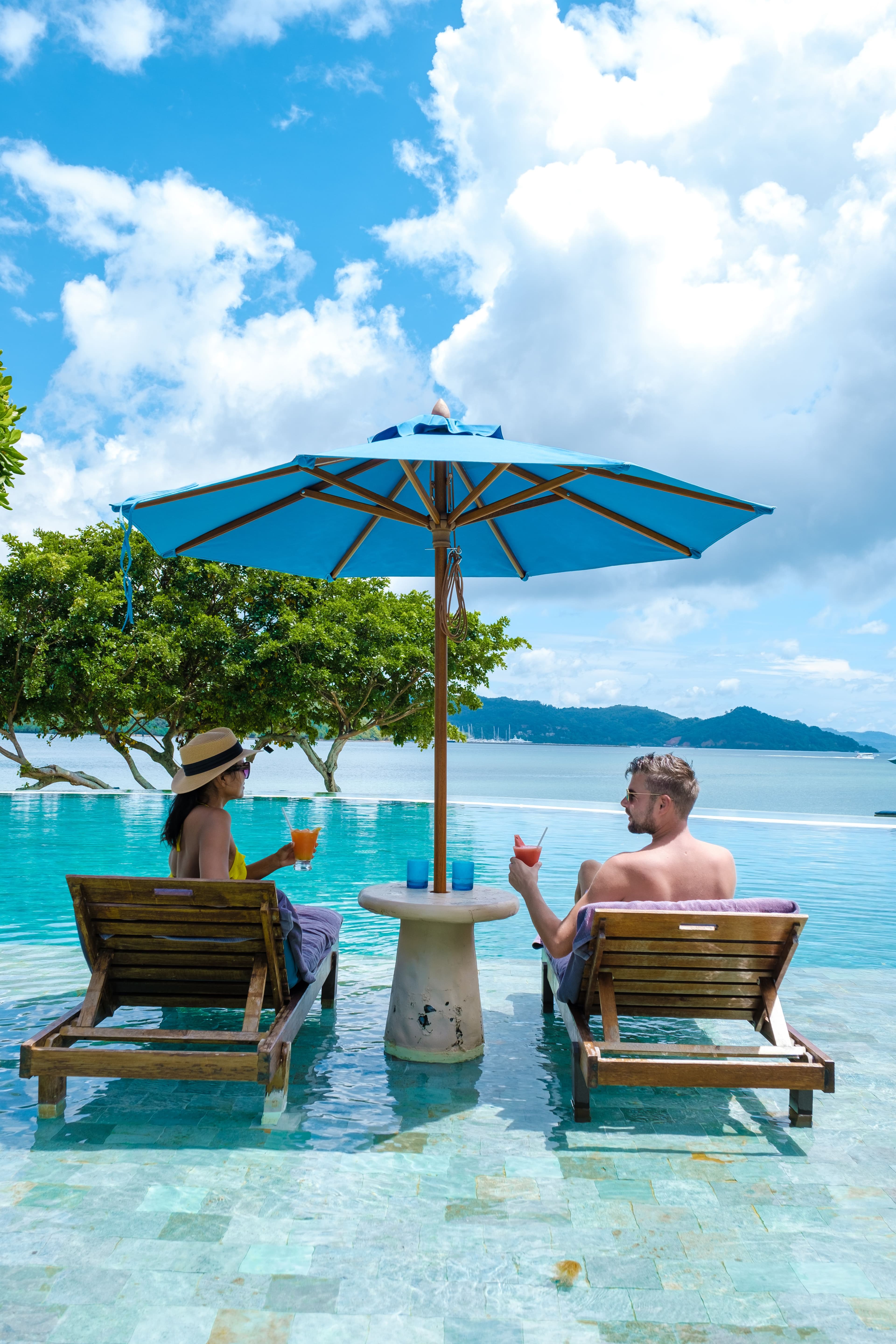 couple european man and asian woman in infinity pool