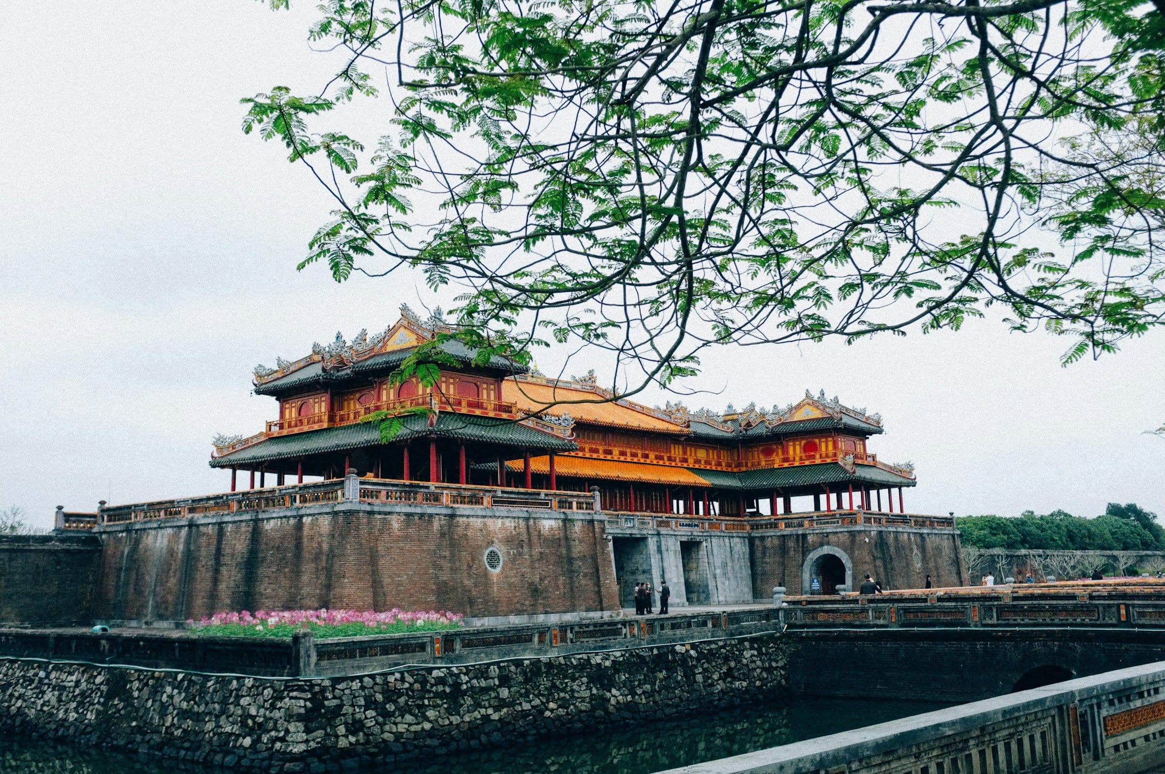 A tiered gate of the imperial citadel at Huế, Vietnam, above its stone walls and moat.