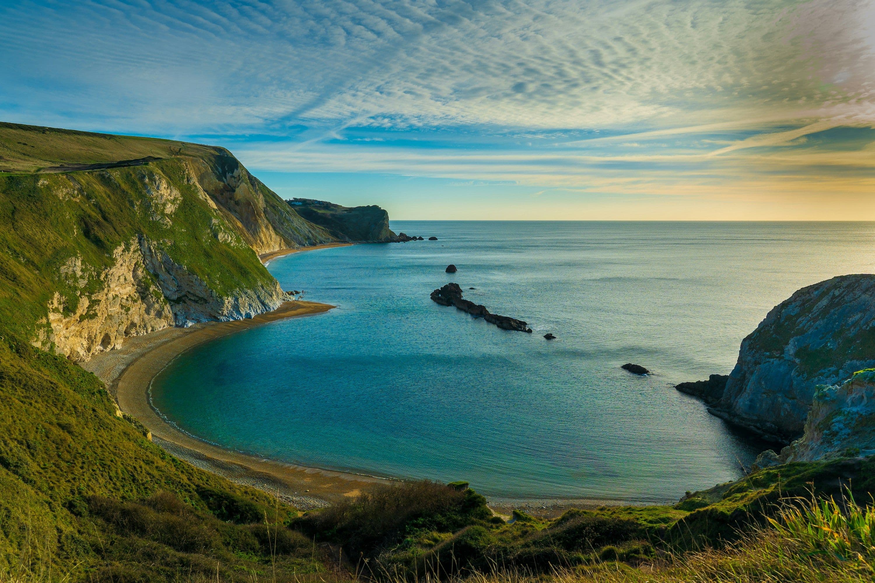 Man O’War Beach, a sheltered turquoise bay beneath green cliffs on the Dorset coast.