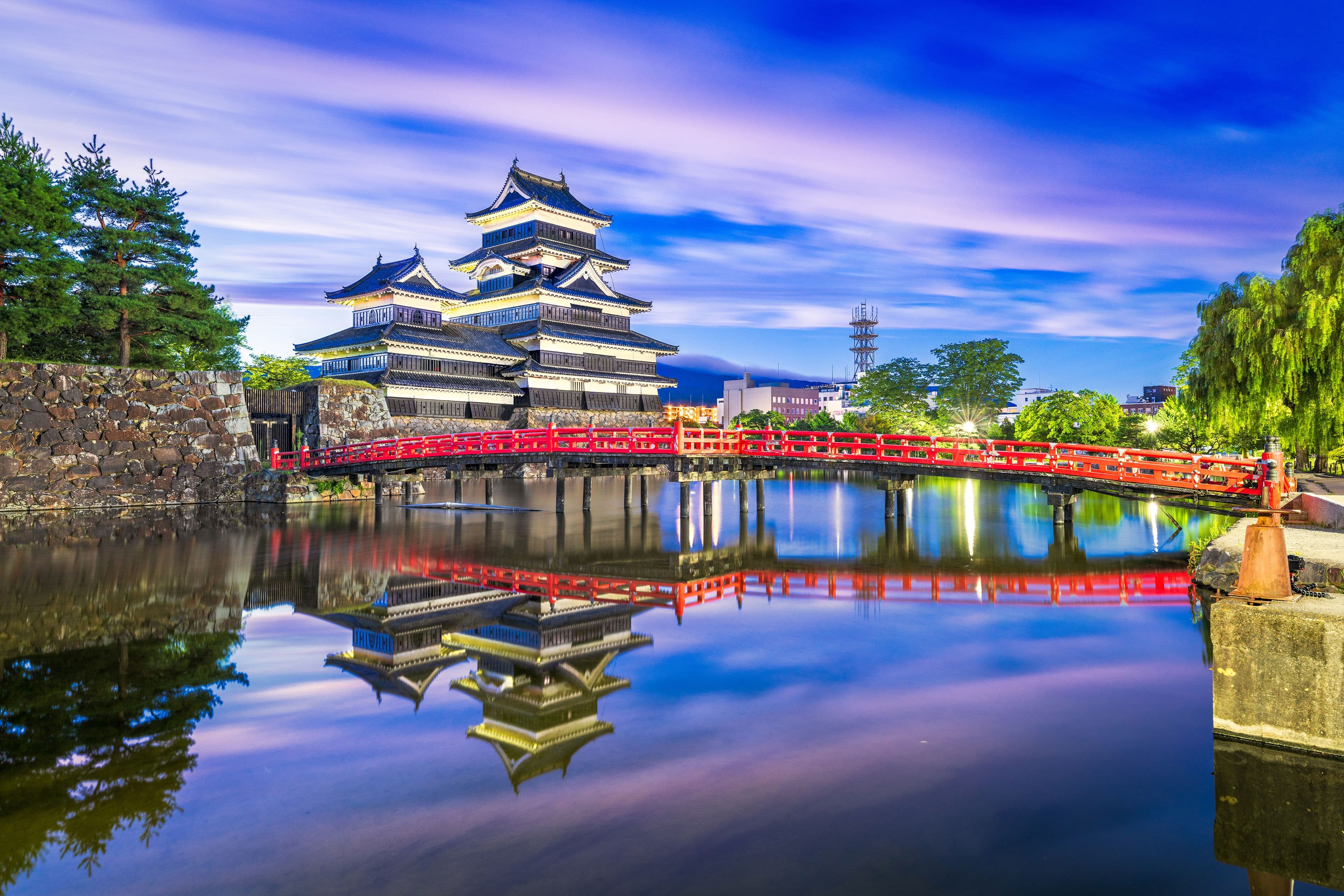 The red Chureito Pagoda overlooking a town and snow-capped Mount Fuji in Japan.