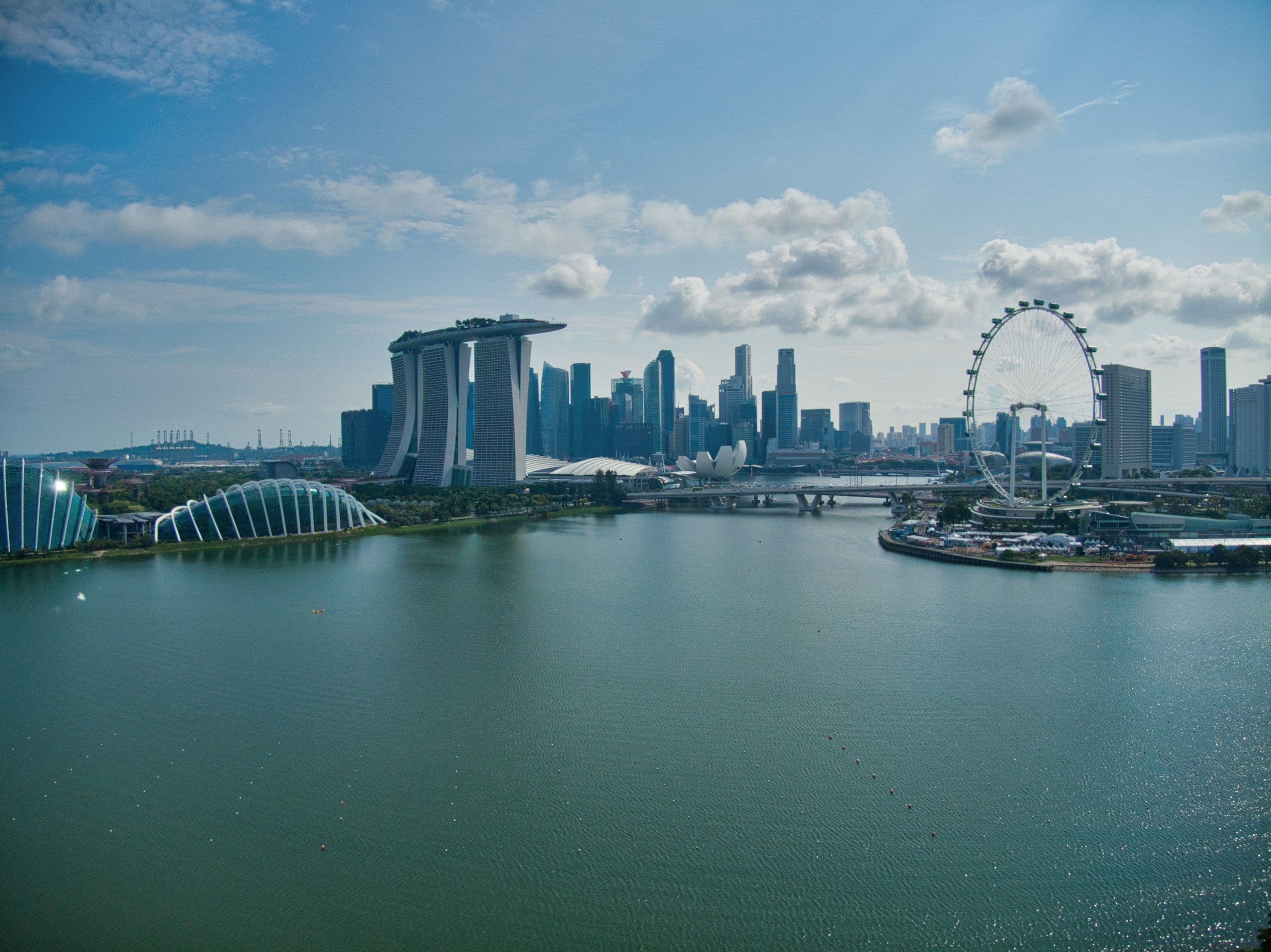 Marina Bay in Singapore seen across the water, with the glasshouses of Gardens by the Bay, the city’s towers and the Singapore Flyer.