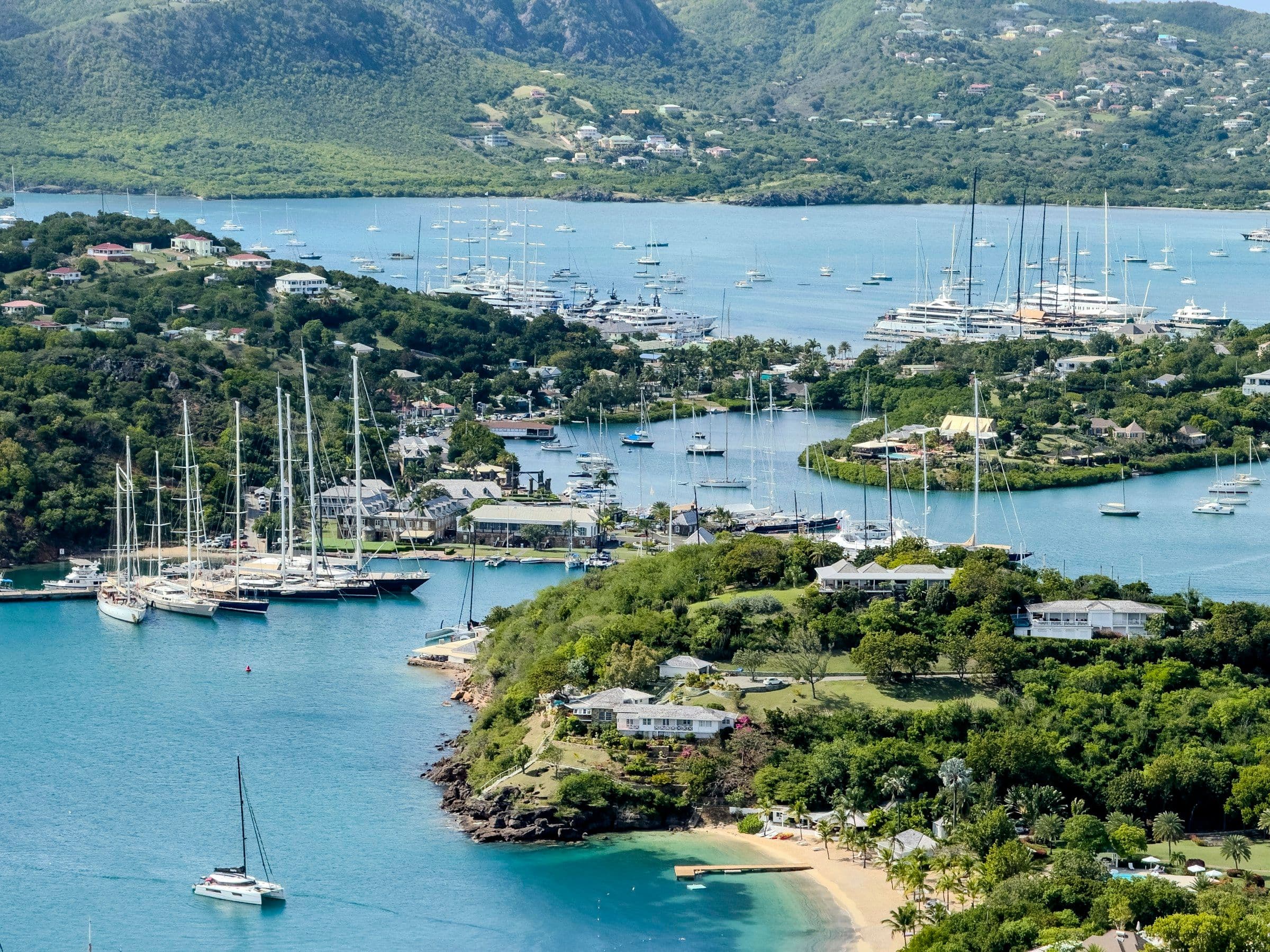 Yachts moored in the sheltered inlets of English Harbour, Antigua, seen from the hills above.