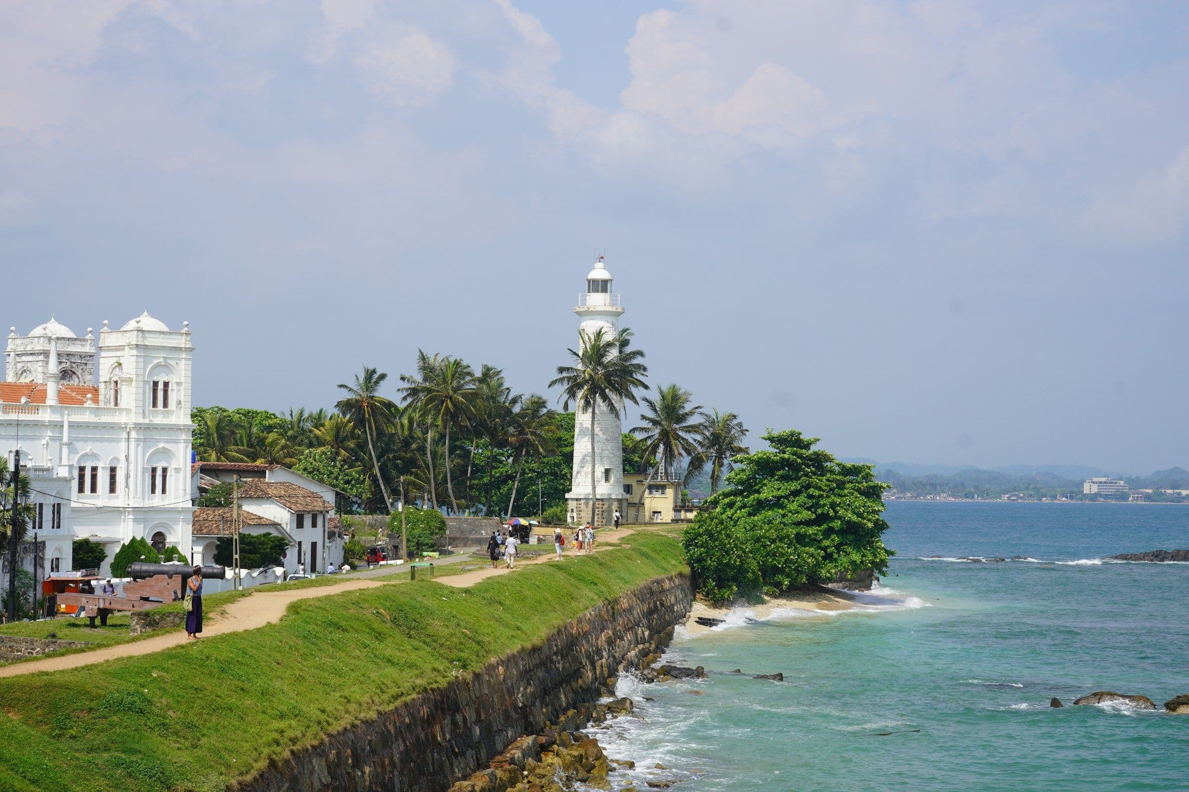 The white lighthouse and grassy ramparts of Galle Fort above the sea on the south coast of Sri Lanka.