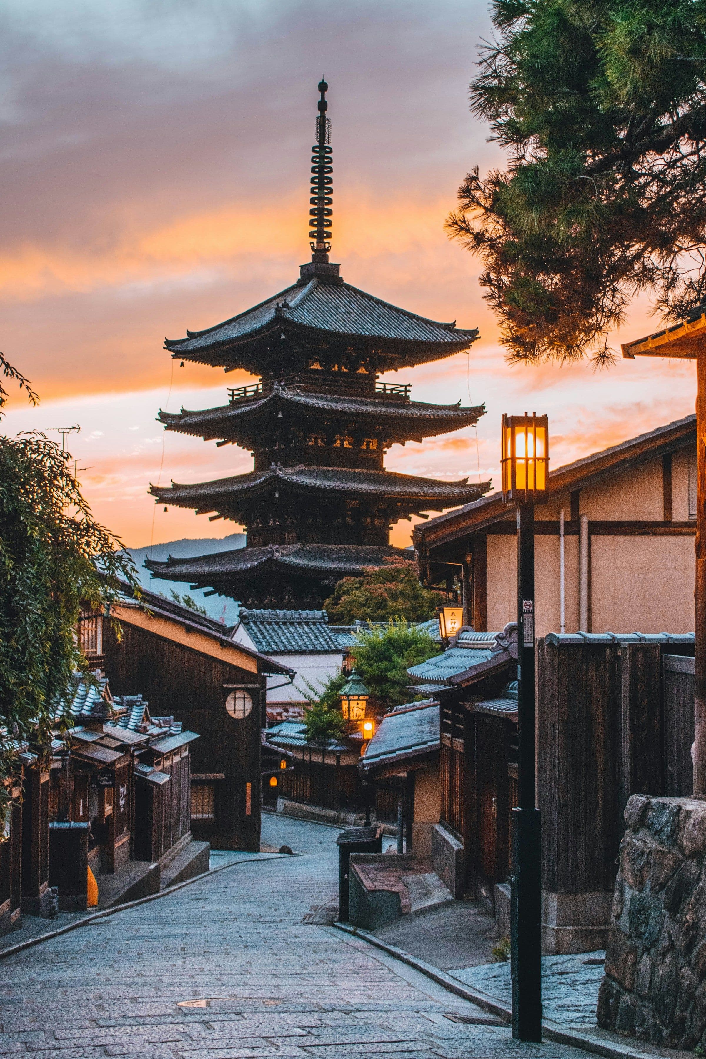 The Yasaka Pagoda at the end of a traditional street in Kyoto, Japan, at dusk.