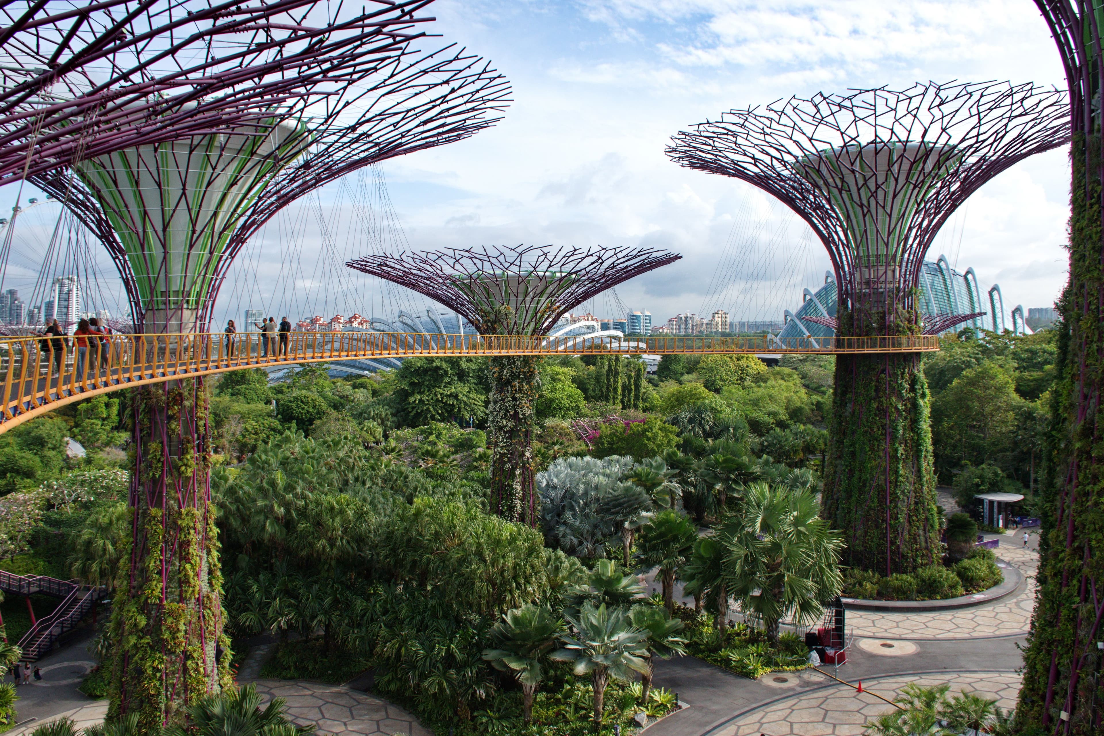 The white bandstand among lawns and trees in the Singapore Botanic Gardens.