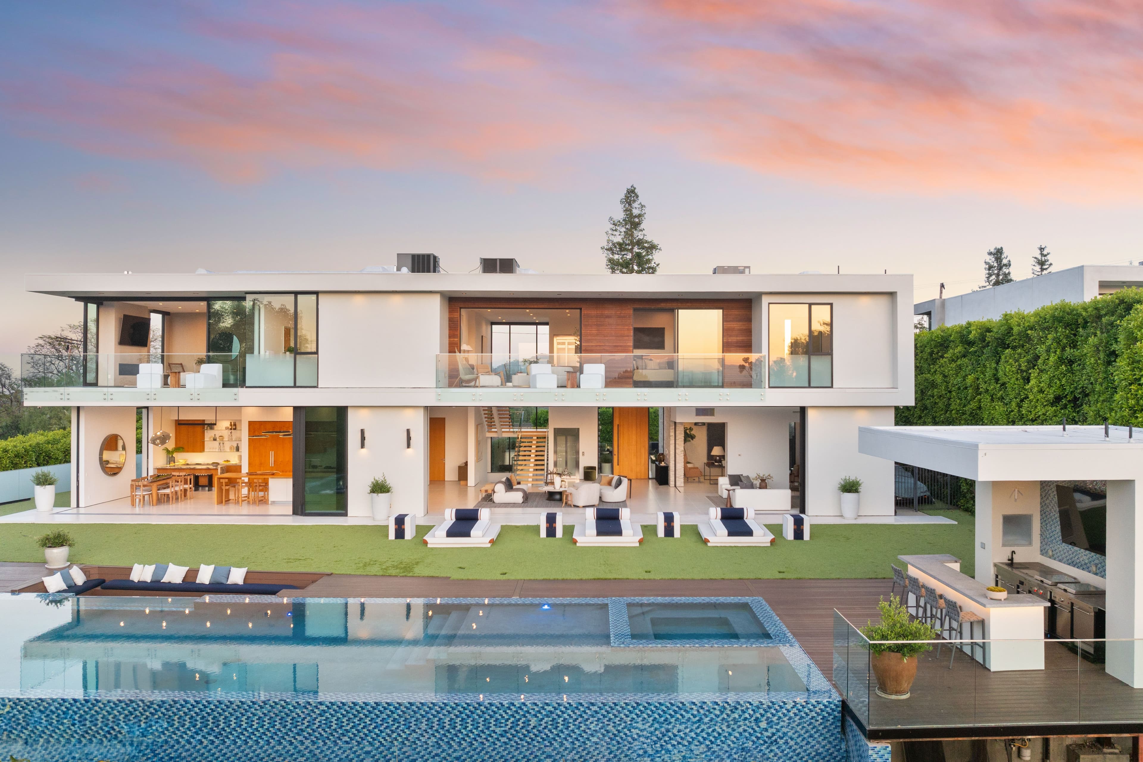 elegant modern villa with a pool at sunset