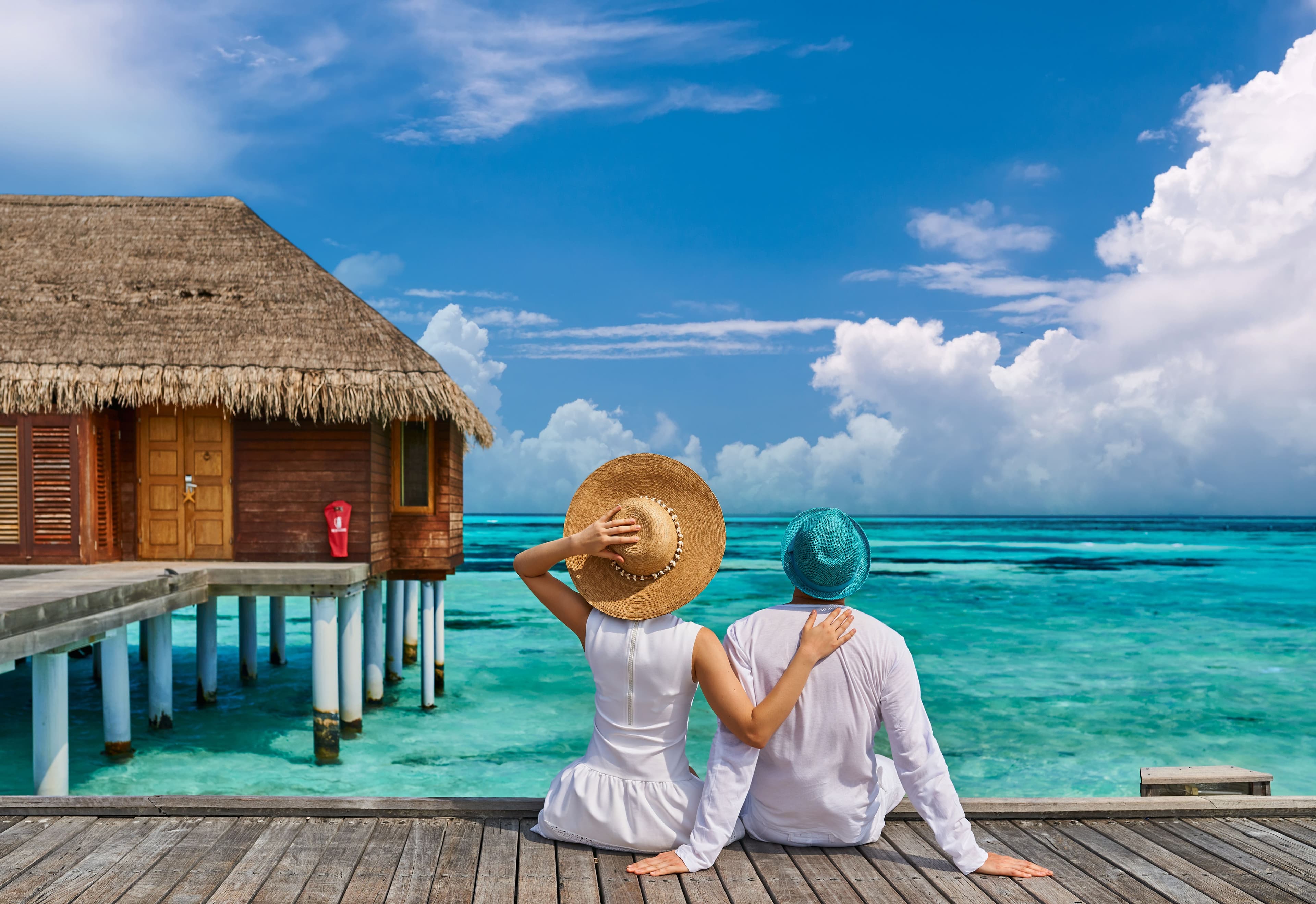 Couple Enjoying Tropical View from Bungalow Deck