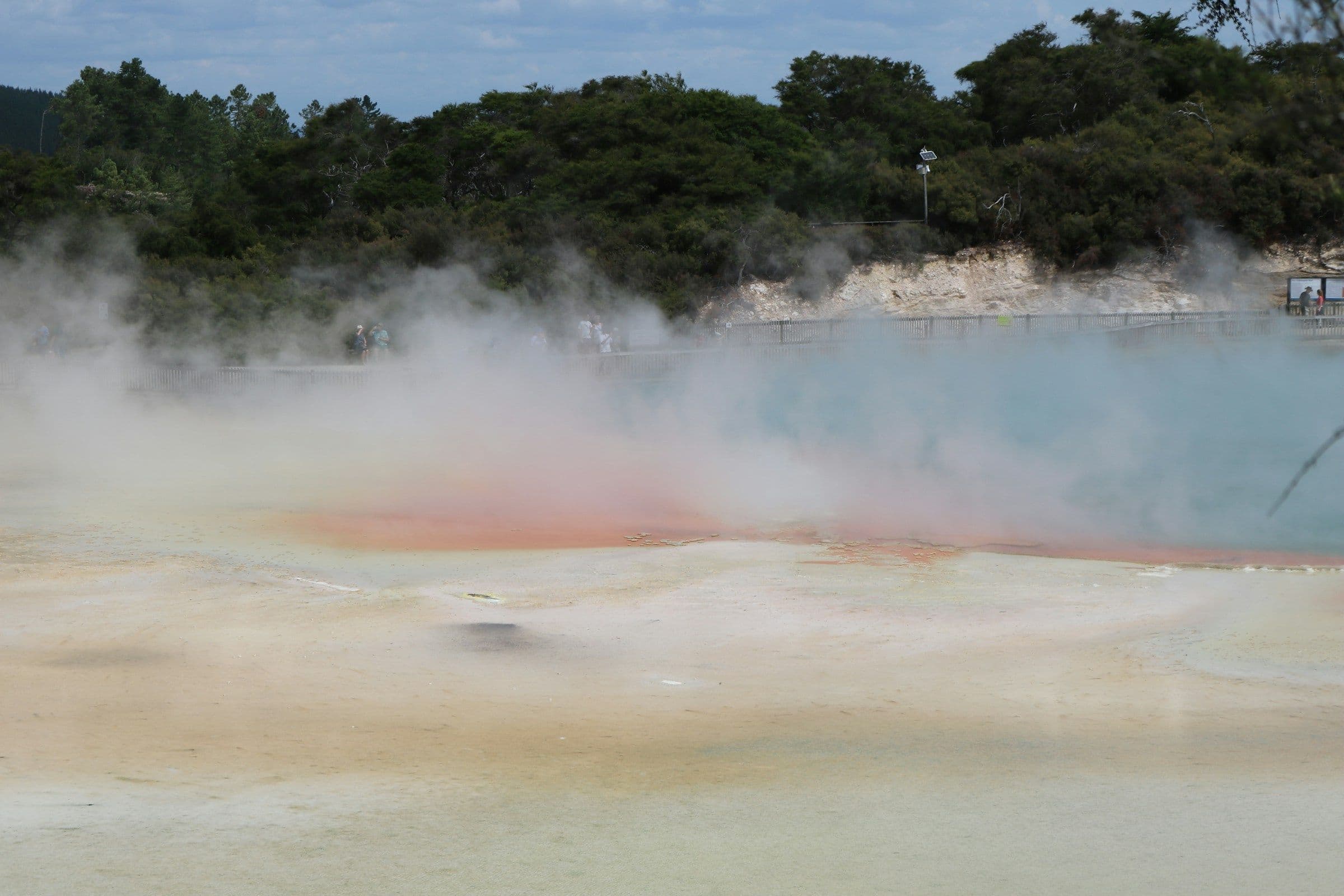 Steam rising from the orange-rimmed Champagne Pool at Wai-O-Tapu, near Rotorua, New Zealand.