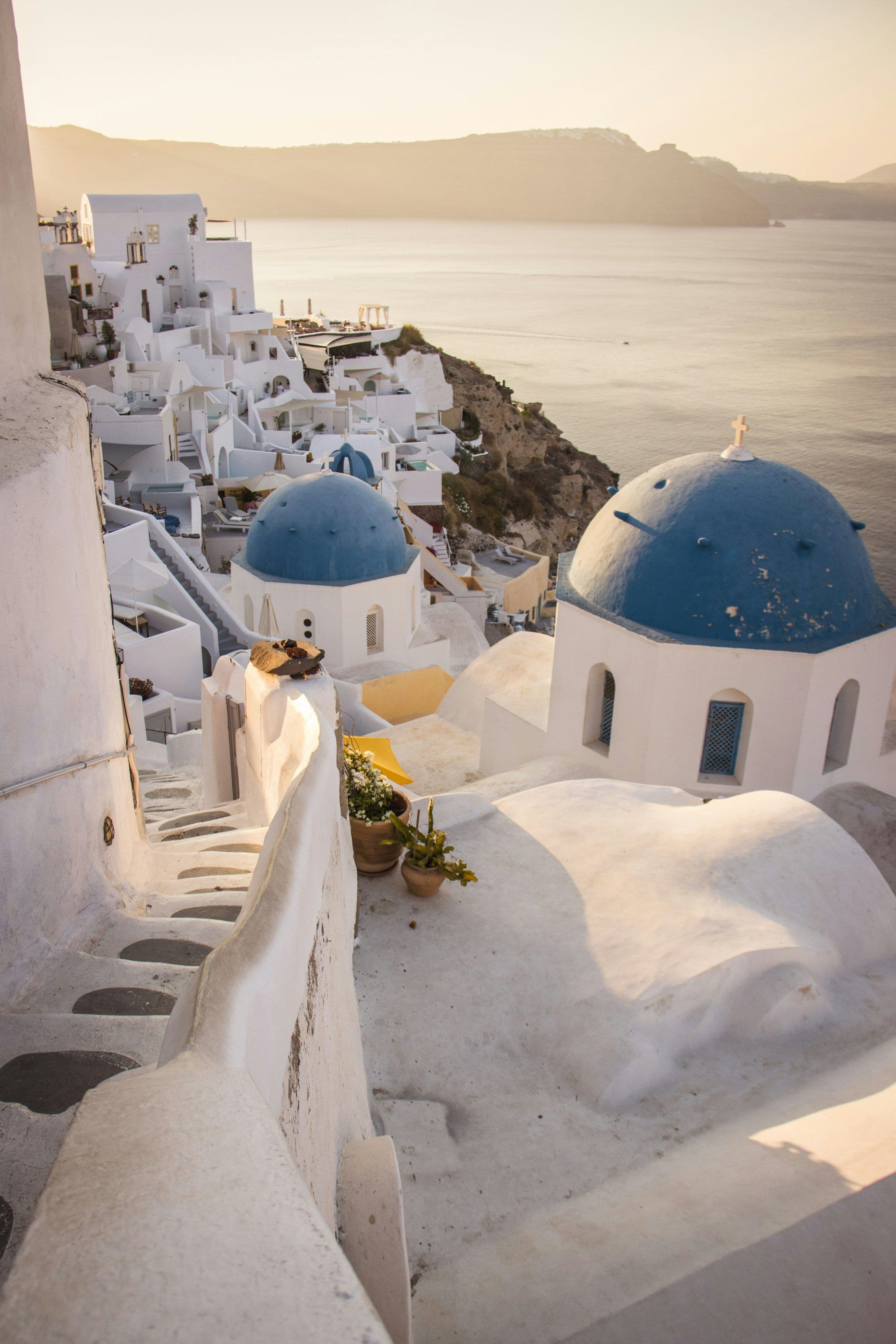 Blue-domed churches and whitewashed houses above the sea at Oia, Santorini.