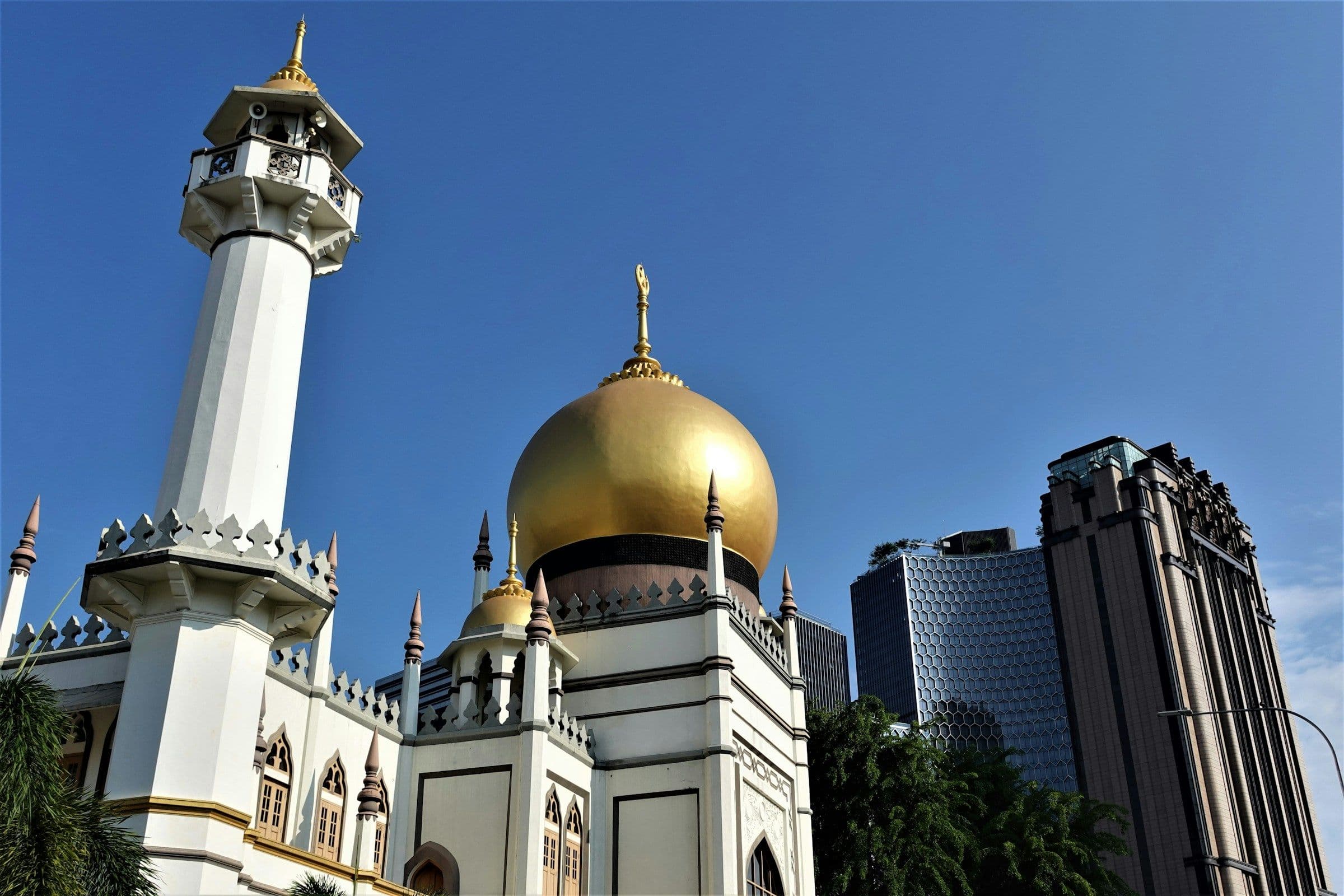 The golden dome and white minarets of the Sultan Mosque in Kampong Glam, Singapore.