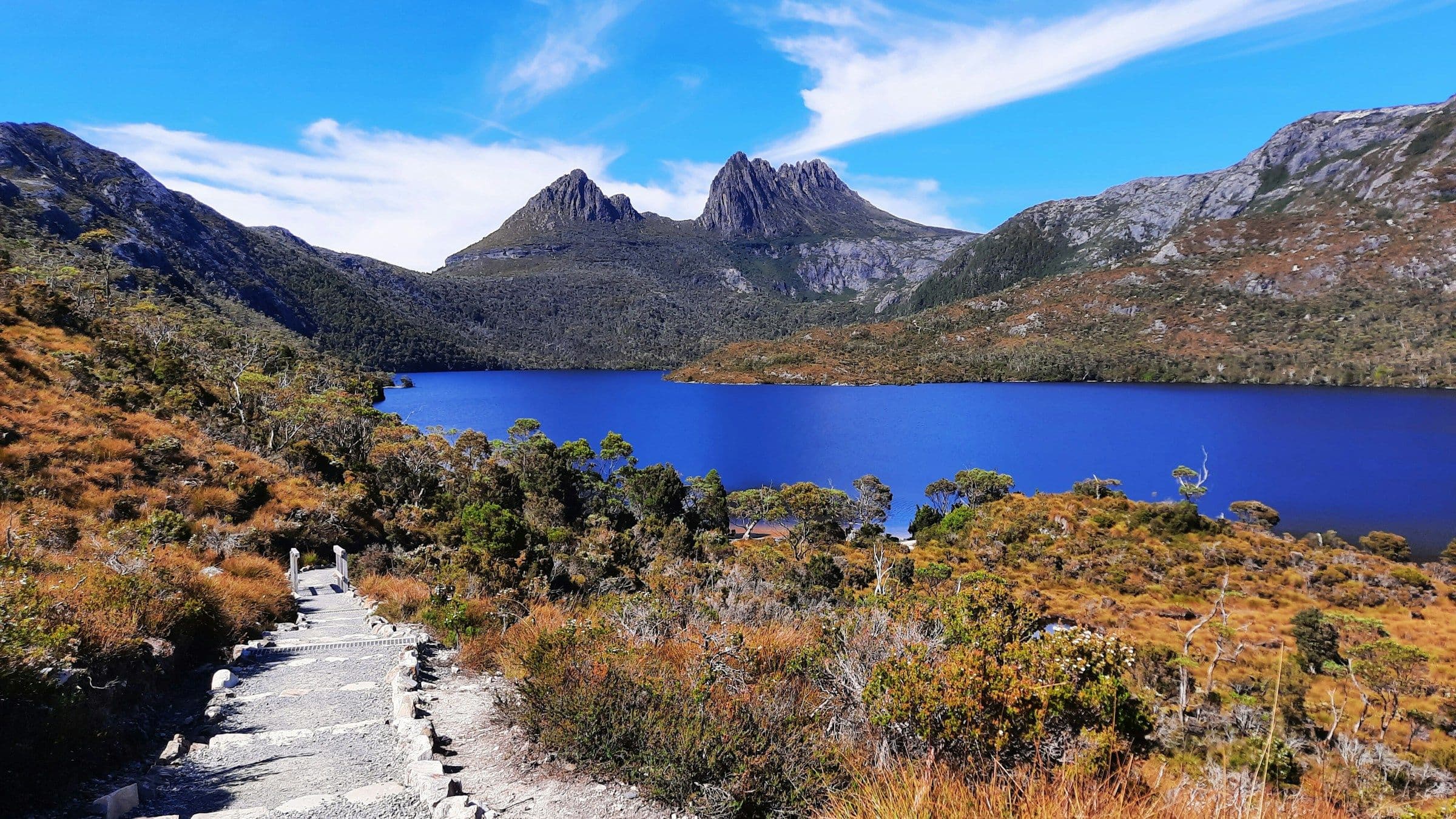 Cradle Mountain above Dove Lake and autumn-coloured heath in Tasmania, Australia.
