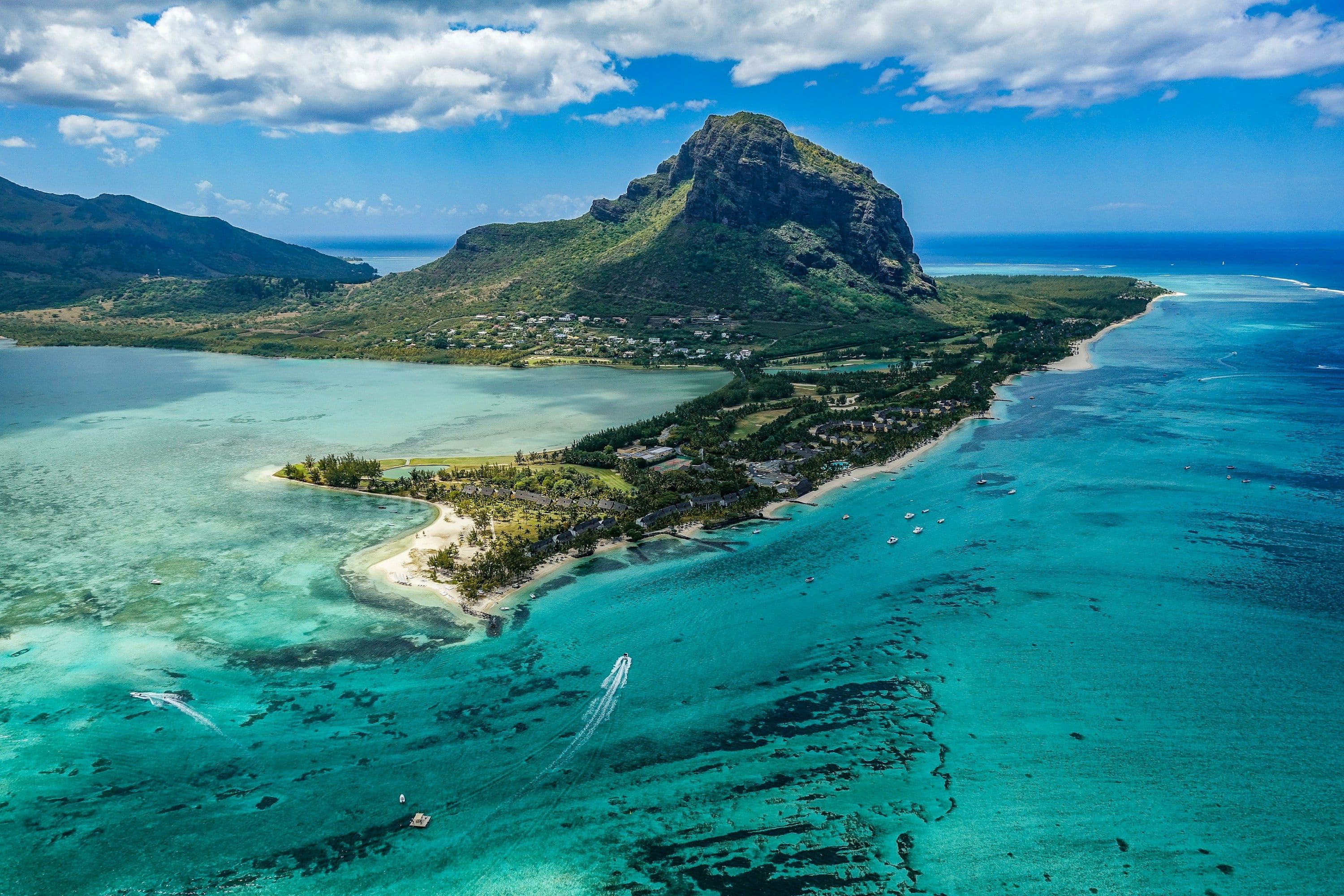 The mountain and peninsula of Le Morne in the south-west of Mauritius, surrounded by a turquoise lagoon, seen from the air.