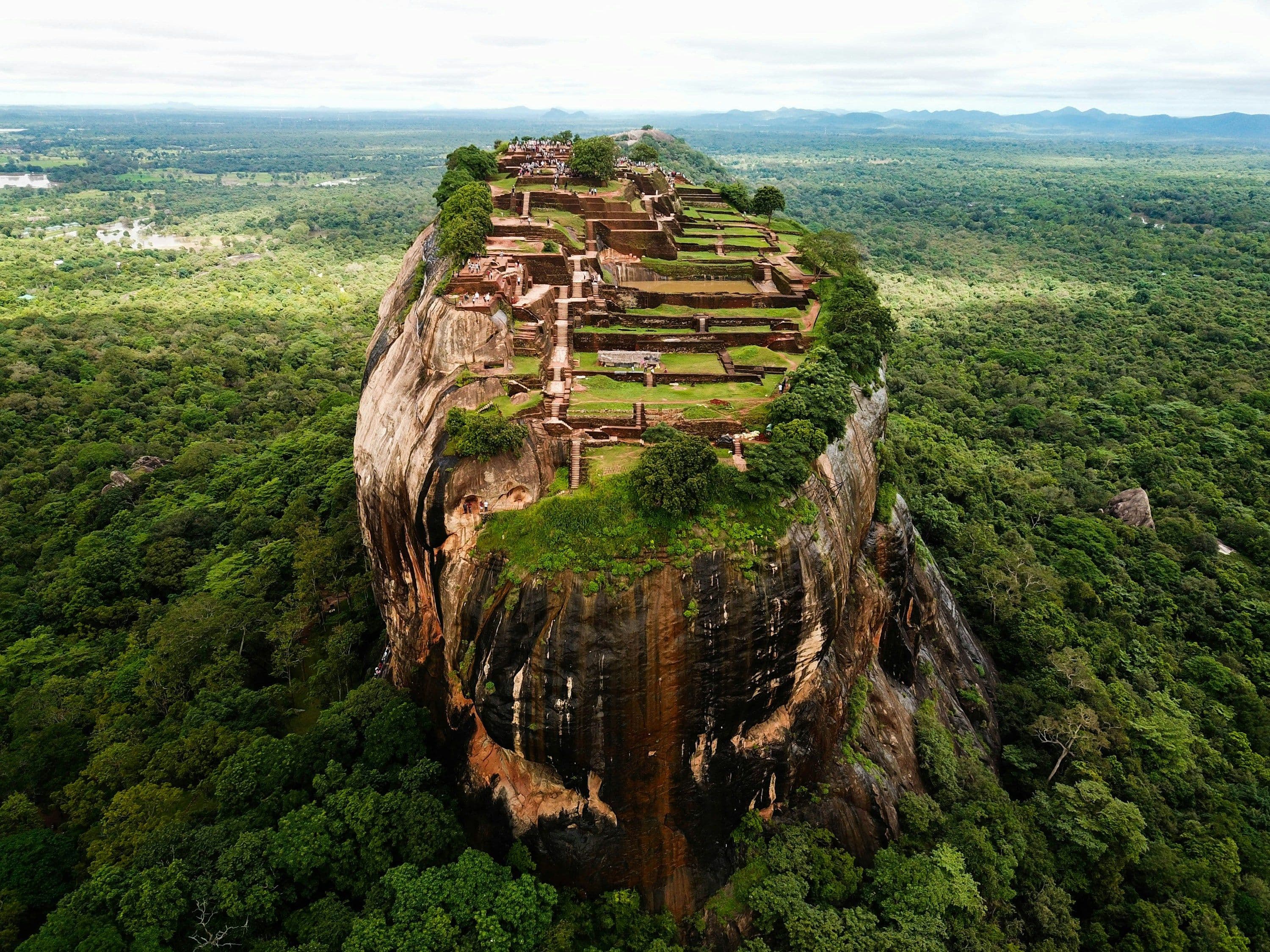 The rock fortress of Sigiriya rising above forest in central Sri Lanka, seen from the air.