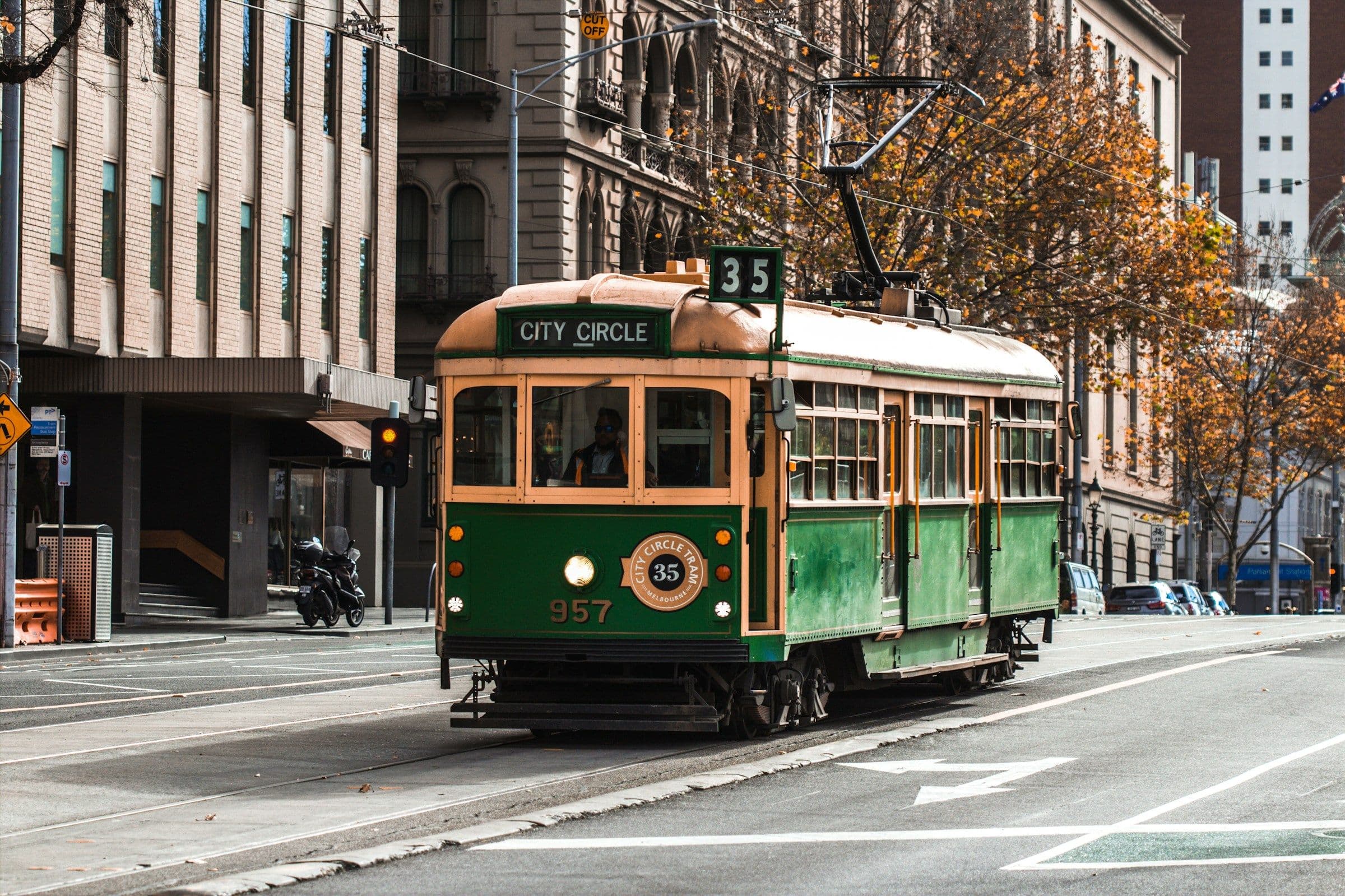A green and gold heritage tram on the City Circle route in the centre of Melbourne, Australia.