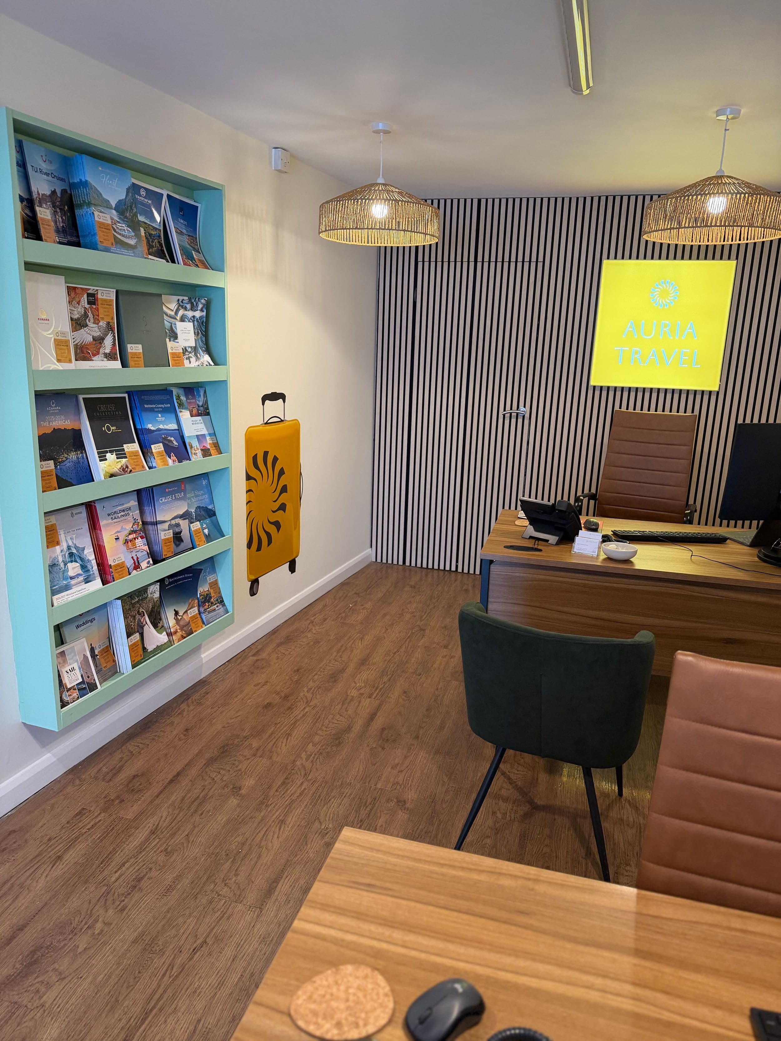 Inside the store: shelves of holiday brochures beside a consultation desk.